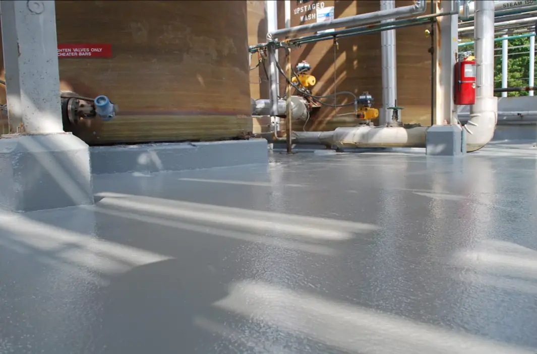 Glossy gray coated floor inside an industrial plant
