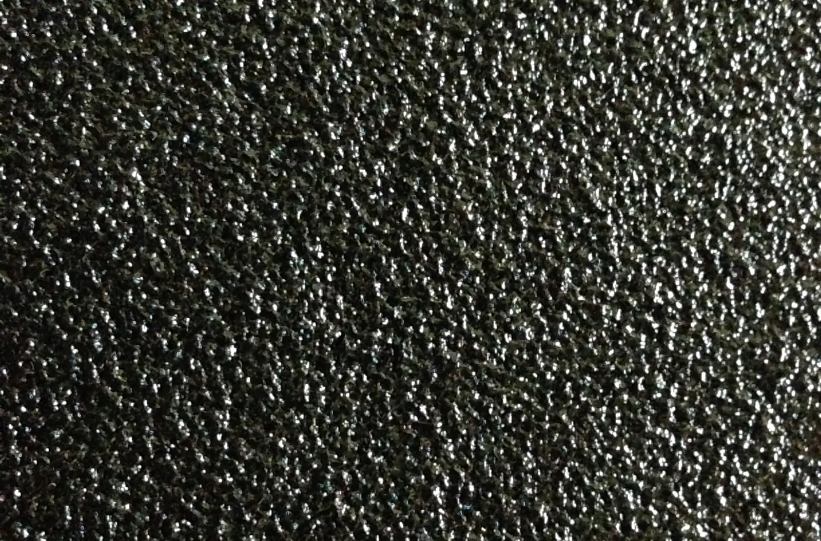 Close view of a black textured spray coating surface